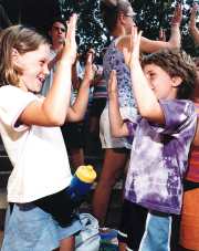 photo of two campers clapping hands at Camp Gray