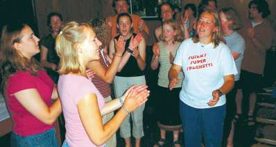 photo of people clapping and singing at end of Mass celebrating Camp Gray's 50th anniversary