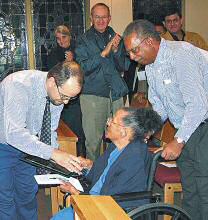 photo of Steve Maurice presenting Lifetime Achievement Award to Arlene Miller, accompanied by her son, Jerry