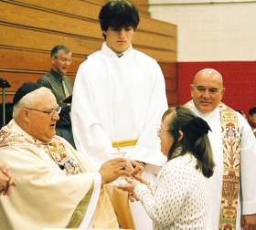 photo of Fr. Ted Borger accepting the Offertory gifts from Artiss Brewster of Janesville