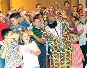 photo of Sr. Elizabeth Mgbaramuko from Ghana dancing with students from St. Bernard School, Watertown