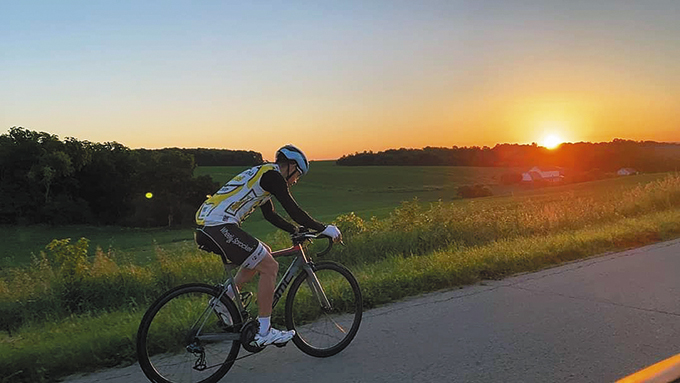 Martin Reza bikes in southern Wisconsin in the summer of 2022 to raise tuition assistance funds for Our Lady of the Assumption School in Beloit. Last year, he biked 300 miles and raised $10,000. He plans to bike this summer for a full 24 hours to raise another $10,000. (Contributed photo)