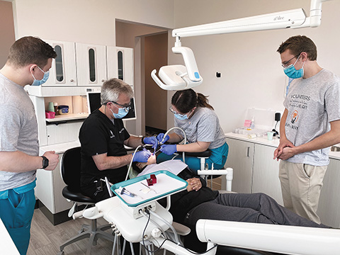 Volunteers from Mercy Dental Group work on a patient at their Middleton location during their first “Day of Mercy” dental care event. During the “Day of Mercy,” free dental care was offered to patients who could not otherwise afford dental services. The group plans to continue to offer these events a couple times a year and hopes to expand it into their nine locations. (Contributed photo)